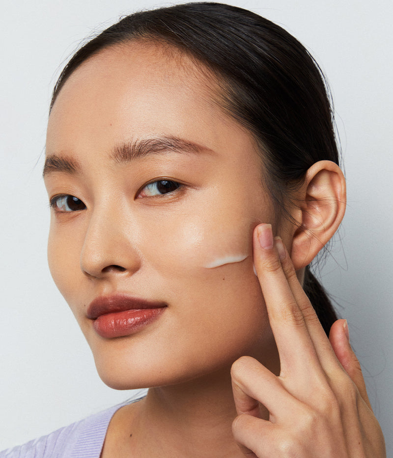 Model with a serum application on her cheek