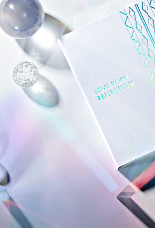 Product on a white background, a box that says "Love your reflection"